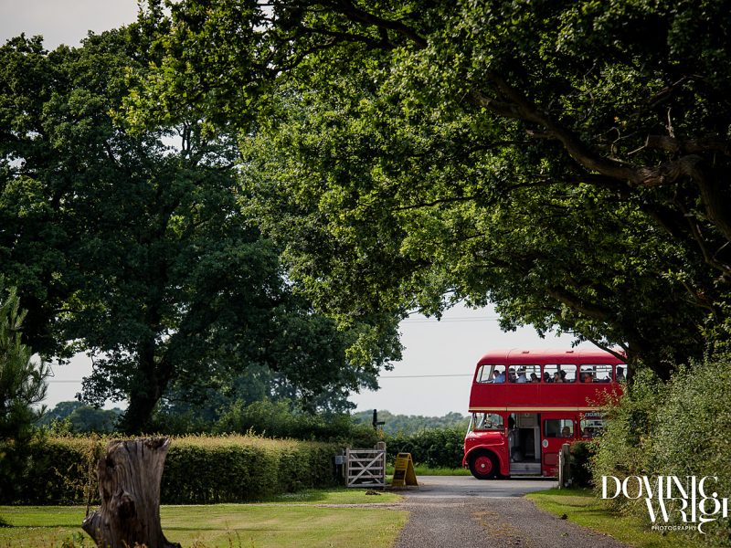 Guests arrive at a rural wedding venue on a double decker bus
